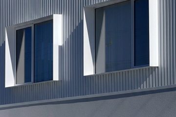 Custom aluminium window shrouds installed on a modern architectural building creating clean façade lines and contemporary design detail